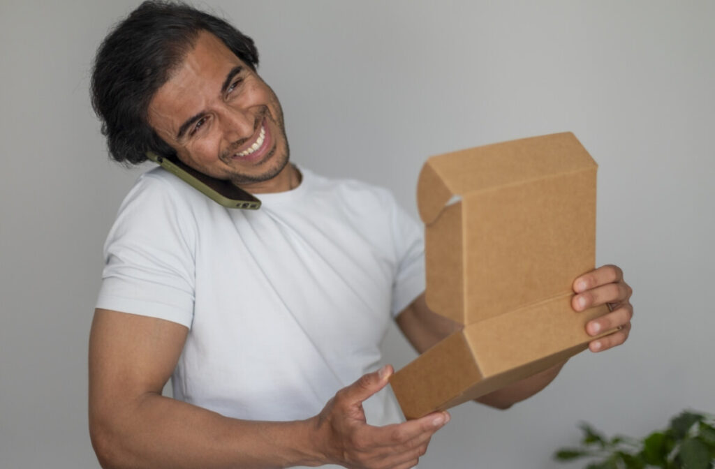 smiling-man-talking-on-the-phone-and-holding-an-op-2025-03-10-05-28-41-utc (1)